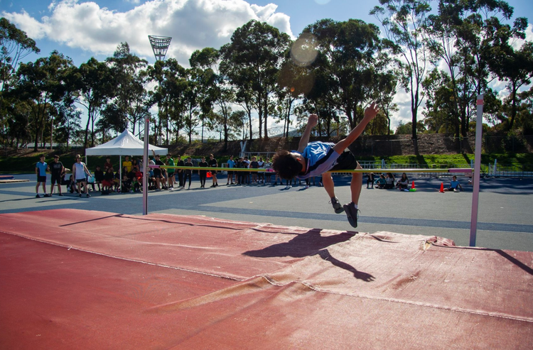 Student competing in high jump