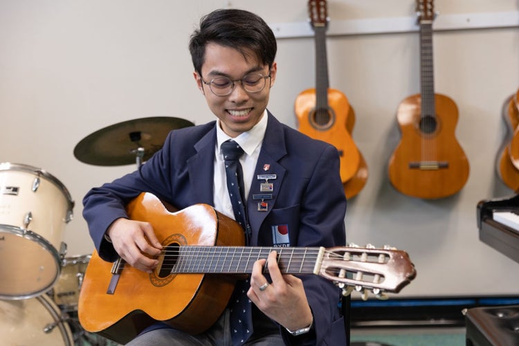 Student playing guitar