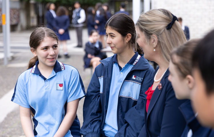Students talking to teacher