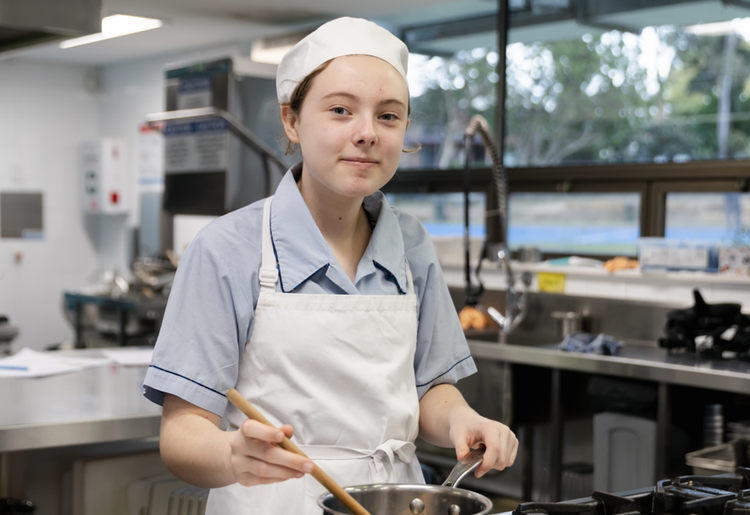 Student cooking with pot