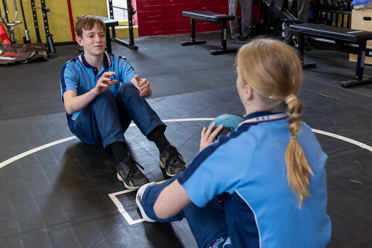 Students throwing medicine ball