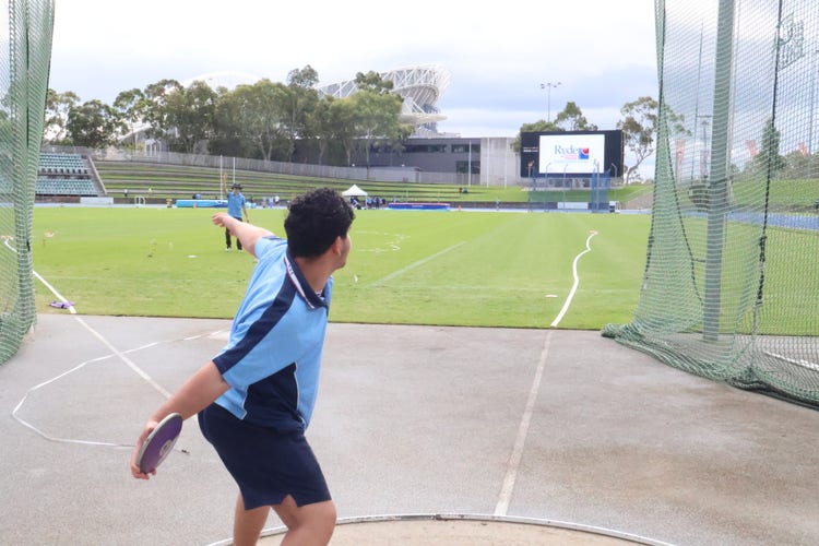 Student throwing discus