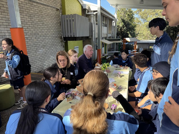 A group of people sitting around a table AI-generated content may be incorrect.